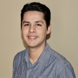 Headshot for Anthony Del Barrio, a young man with dark hair wearing a grey button-down shirt