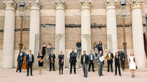 Musicians posed in front of roman columns