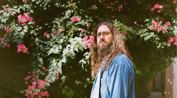 Nate Mercereau in front of flowers