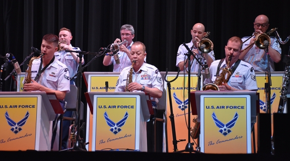 An ensemble of people in uniform playing big band jazz